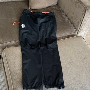 Bjorn Daehlie Black Nordic Pants with Orange Accents, full side zips